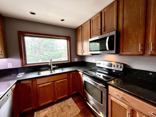 268 Clayburne Blvd, Chillicothe, OH 45601 - kitchen featuring stainless steel appliances, brown cabinets, dark tile patterned flooring, dark stone counters, and recessed lighting