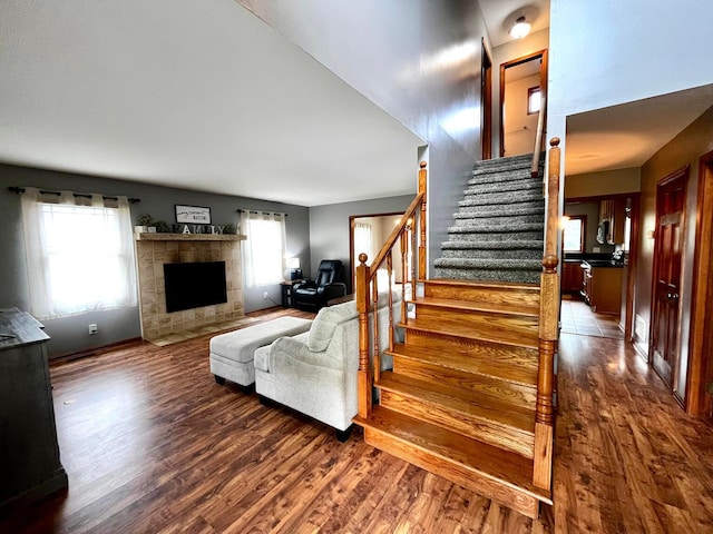 268 Clayburne Blvd, Chillicothe, OH 45601 - living room featuring wood finished floors, stairway, and a tiled fireplace