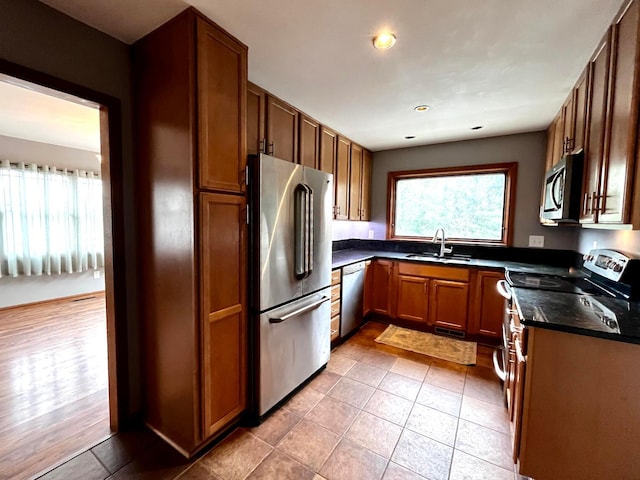 268 Clayburne Blvd, Chillicothe, OH 45601 - kitchen with stainless steel appliances, dark countertops, brown cabinets, recessed lighting, and light tile patterned floors