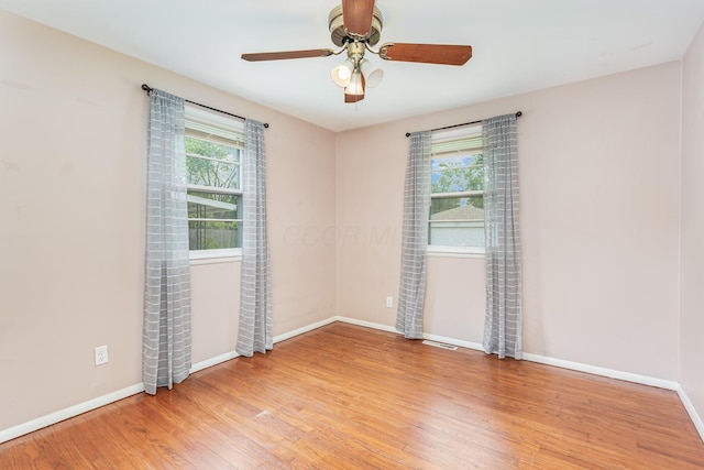 2115 Case Rd, Columbus, OH 43224 - empty room with plenty of natural light, light wood-style flooring, and ceiling fan