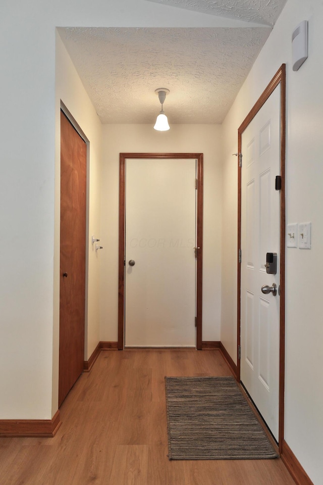3808 Peak Ridge Dr, Columbus, OH 43230 - hallway featuring light wood-style flooring and a textured ceiling