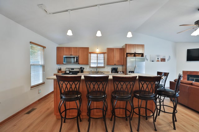 3808 Peak Ridge Dr, Columbus, OH 43230 - kitchen featuring stainless steel appliances, lofted ceiling, open floor plan, light wood finished floors, and healthy amount of natural light