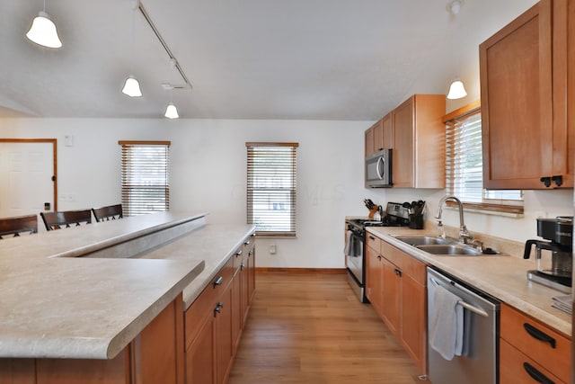 3808 Peak Ridge Dr, Columbus, OH 43230 - kitchen featuring stainless steel appliances, light wood finished floors, a center island, and plenty of natural light