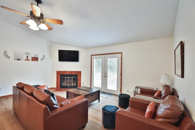 3808 Peak Ridge Dr, Columbus, OH 43230 - living area featuring light wood-type flooring, a fireplace, french doors, a ceiling fan, and a textured ceiling