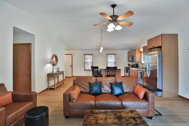 3808 Peak Ridge Dr, Columbus, OH 43230 - living room with lofted ceiling, light wood-style flooring, and a ceiling fan