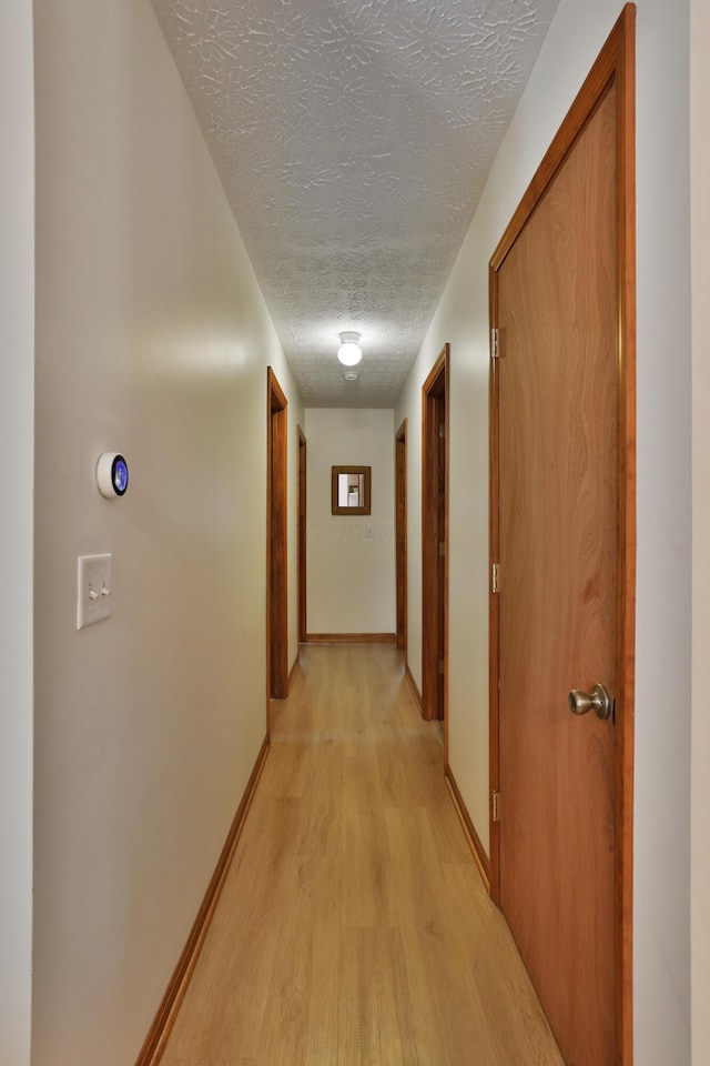 3808 Peak Ridge Dr, Columbus, OH 43230 - corridor with a textured ceiling and light wood-type flooring