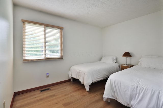 3808 Peak Ridge Dr, Columbus, OH 43230 - bedroom featuring wood finished floors and a textured ceiling
