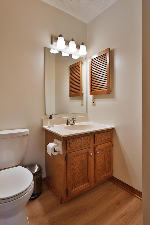3808 Peak Ridge Dr, Columbus, OH 43230 - half bath with wood finished floors, vanity, and a textured ceiling