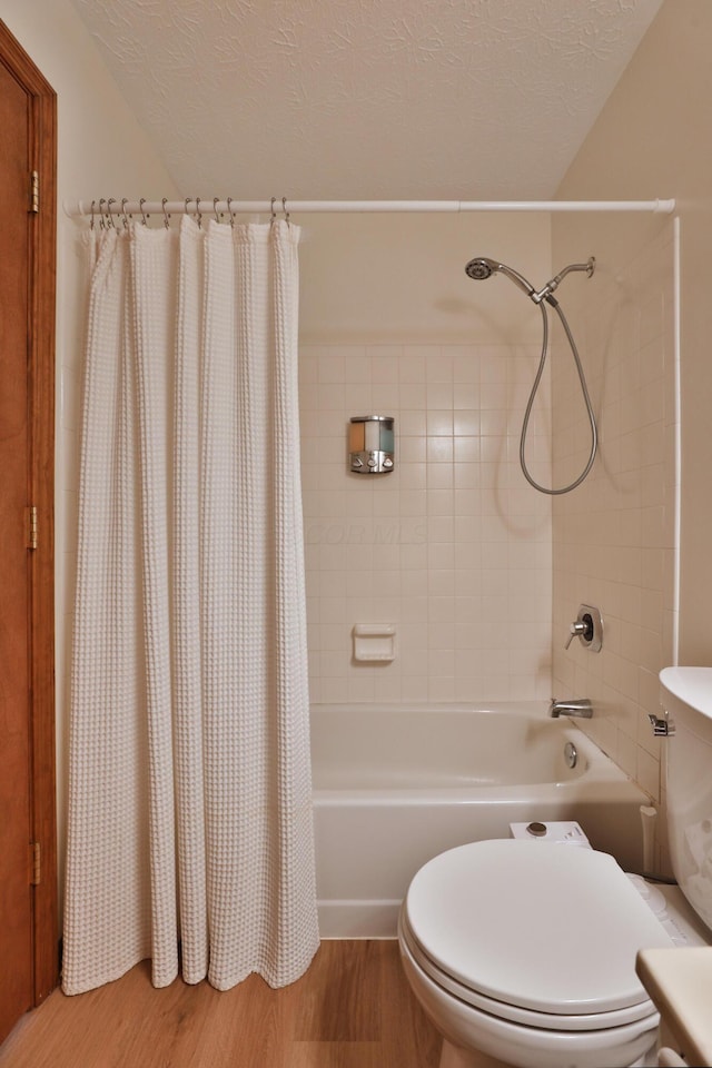 3808 Peak Ridge Dr, Columbus, OH 43230 - full bath with shower / tub combo with curtain, wood finished floors, and a textured ceiling