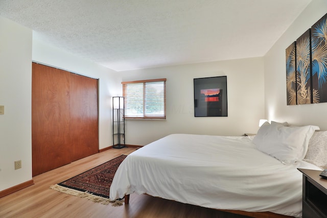 3808 Peak Ridge Dr, Columbus, OH 43230 - bedroom with wood finished floors, a closet, and a textured ceiling