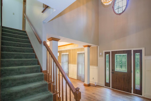 7740 Gale Rd SW, Hebron, OH 43025 - foyer entrance featuring hardwood / wood-style flooring, stairway, a towering ceiling, and wainscoting