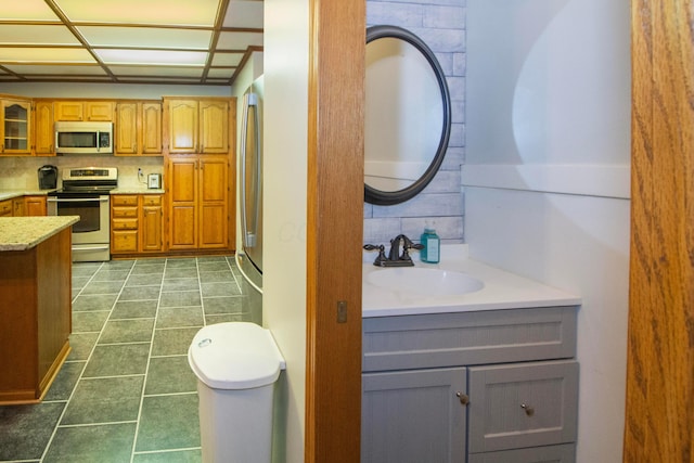 7740 Gale Rd SW, Hebron, OH 43025 - bathroom featuring vanity, tasteful backsplash, and tile patterned floors