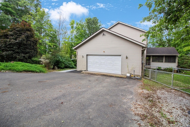 7740 Gale Rd SW, Hebron, OH 43025 - view of side of home featuring asphalt driveway and a garage