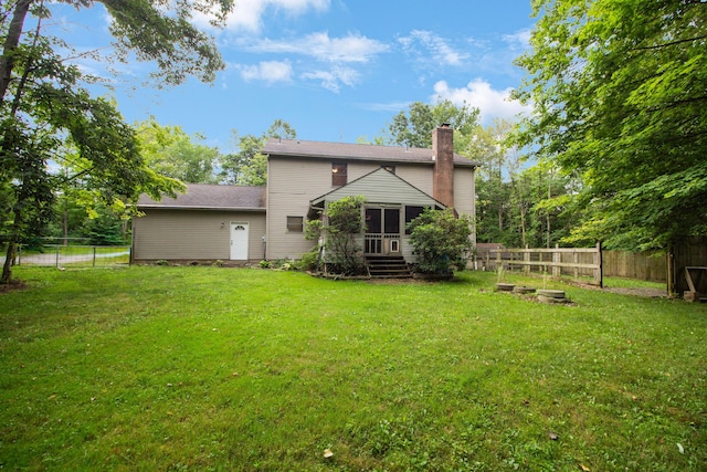 7740 Gale Rd SW, Hebron, OH 43025 - rear view of property featuring a chimney, a fenced backyard, and a sunroom