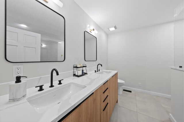 2560 Zollinger Rd, Columbus, OH 43221 - bathroom featuring double vanity and tile patterned floors