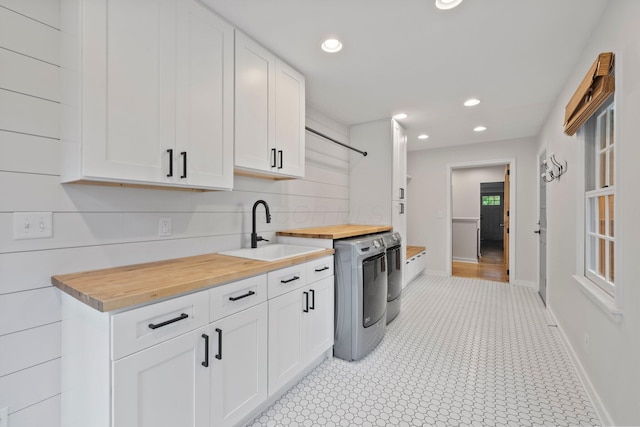 2560 Zollinger Rd, Columbus, OH 43221 - kitchen featuring wood counters, washer and clothes dryer, white cabinetry, recessed lighting, and backsplash