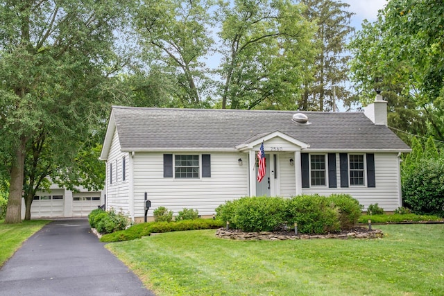 2560 Zollinger Rd, Columbus, OH 43221 - ranch-style home featuring an outbuilding, a chimney, a front yard, a detached garage, and a shingled roof