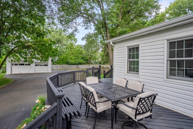 2560 Zollinger Rd, Columbus, OH 43221 - wooden terrace featuring outdoor dining space and an outdoor structure