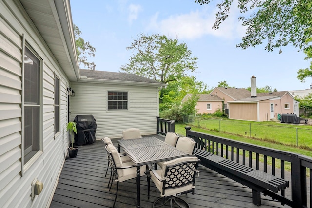 2560 Zollinger Rd, Columbus, OH 43221 - wooden deck with area for grilling, outdoor dining area, and a fenced backyard