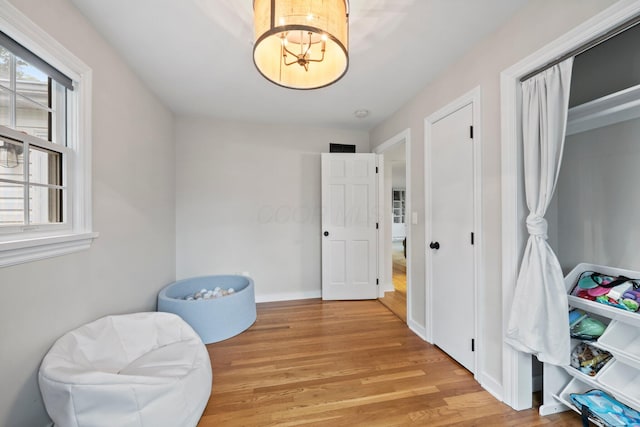 2560 Zollinger Rd, Columbus, OH 43221 - living area featuring a chandelier and light wood-style floors