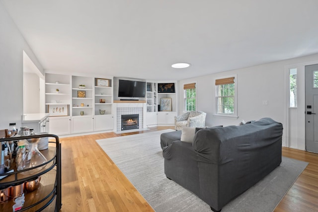 2560 Zollinger Rd, Columbus, OH 43221 - living area featuring healthy amount of natural light, light wood-type flooring, and a tile fireplace