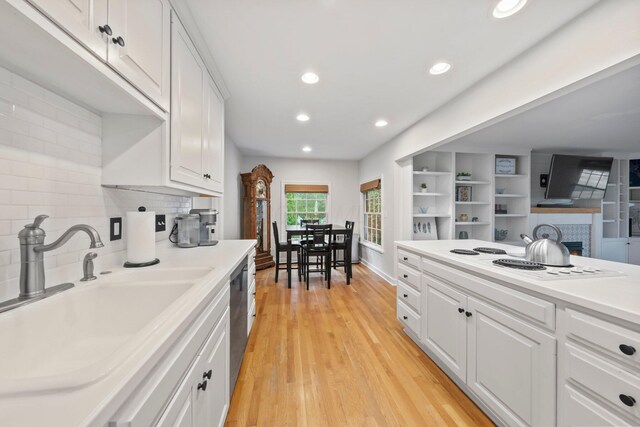 2560 Zollinger Rd, Columbus, OH 43221 - kitchen featuring white electric stovetop, white cabinets, tasteful backsplash, light countertops, and recessed lighting