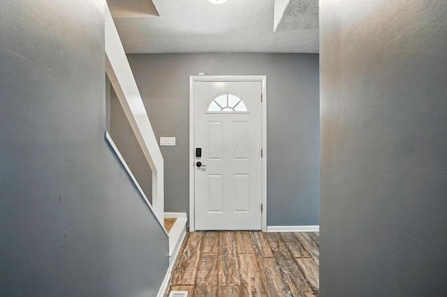 2605 Bella Via Ave, Columbus, OH 43231 - doorway featuring wood finished floors, stairs, and a textured ceiling