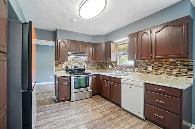 2605 Bella Via Ave, Columbus, OH 43231 - kitchen featuring electric stove, white dishwasher, under cabinet range hood, light wood-style flooring, and freestanding refrigerator