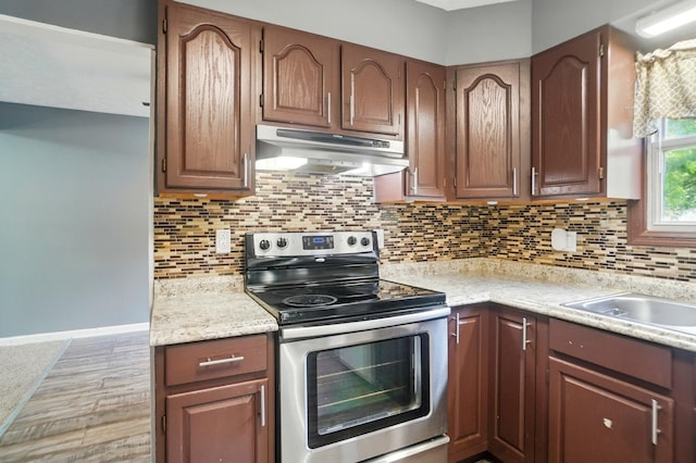 2605 Bella Via Ave, Columbus, OH 43231 - kitchen featuring electric stove, under cabinet range hood, light countertops, and tasteful backsplash