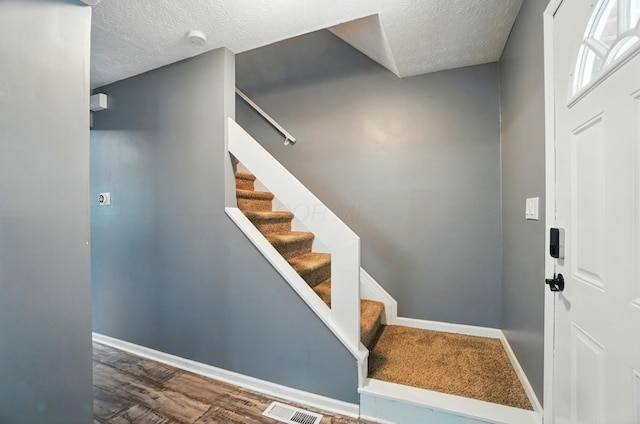 2605 Bella Via Ave, Columbus, OH 43231 - stairs with a textured ceiling and wood finished floors