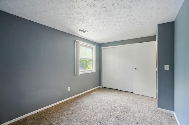 2605 Bella Via Ave, Columbus, OH 43231 - unfurnished bedroom featuring carpet, a closet, and a textured ceiling
