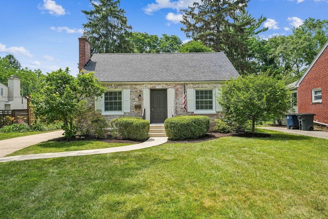 527 N Columbia Ave, Bexley, OH 43209 - new england style home with a front yard, a shingled roof, and a chimney