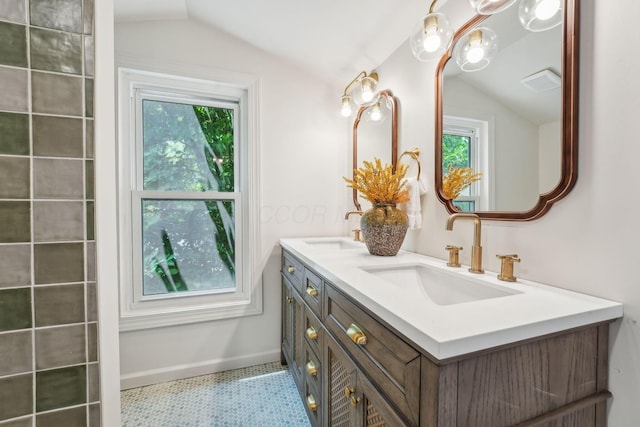 527 N Columbia Ave, Bexley, OH 43209 - bathroom featuring lofted ceiling, double vanity, and plenty of natural light