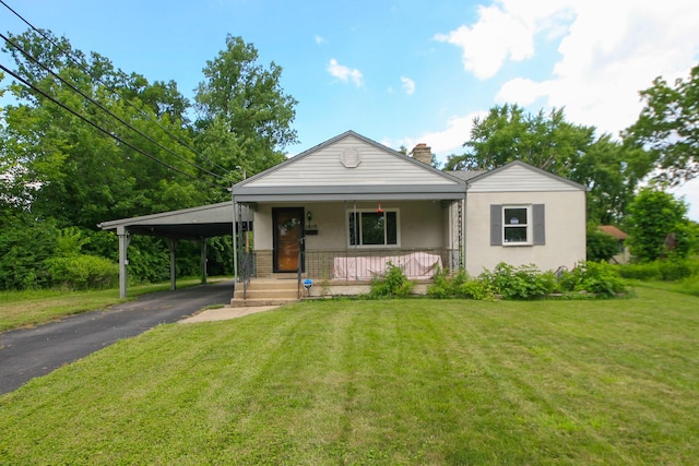 1810 Lehner Rd, Columbus, OH 43224 - view of front facade featuring covered porch, driveway, a front yard, and stucco siding