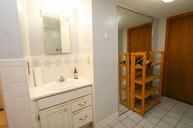 1810 Lehner Rd, Columbus, OH 43224 - bathroom featuring vanity, tile patterned flooring, wainscoting, and a textured ceiling