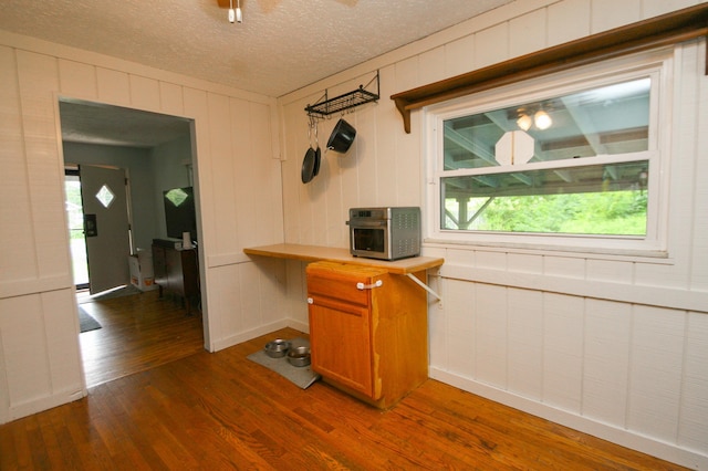 1810 Lehner Rd, Columbus, OH 43224 - kitchen featuring dark wood-style flooring, brown cabinets, and a textured ceiling