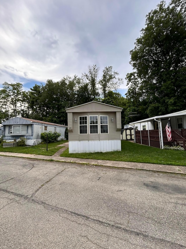 110 E Hickory Grove Rd Unit 45, Urbana, OH 43078 - manufactured / mobile home featuring a front lawn and an outbuilding