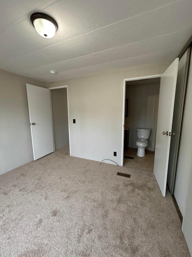 110 E Hickory Grove Rd Unit 45, Urbana, OH 43078 - unfurnished bedroom featuring carpet flooring and connected bathroom