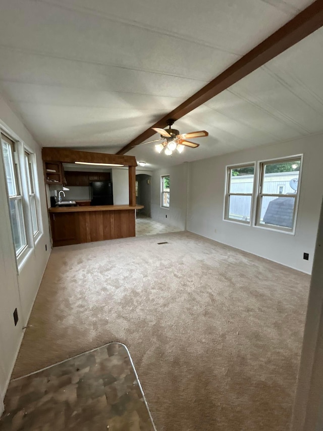 110 E Hickory Grove Rd Unit 45, Urbana, OH 43078 - unfurnished living room with beam ceiling, light carpet, and a ceiling fan