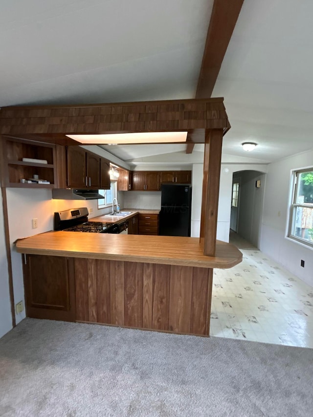 110 E Hickory Grove Rd Unit 45, Urbana, OH 43078 - kitchen with freestanding refrigerator, light countertops, a peninsula, light colored carpet, and beam ceiling