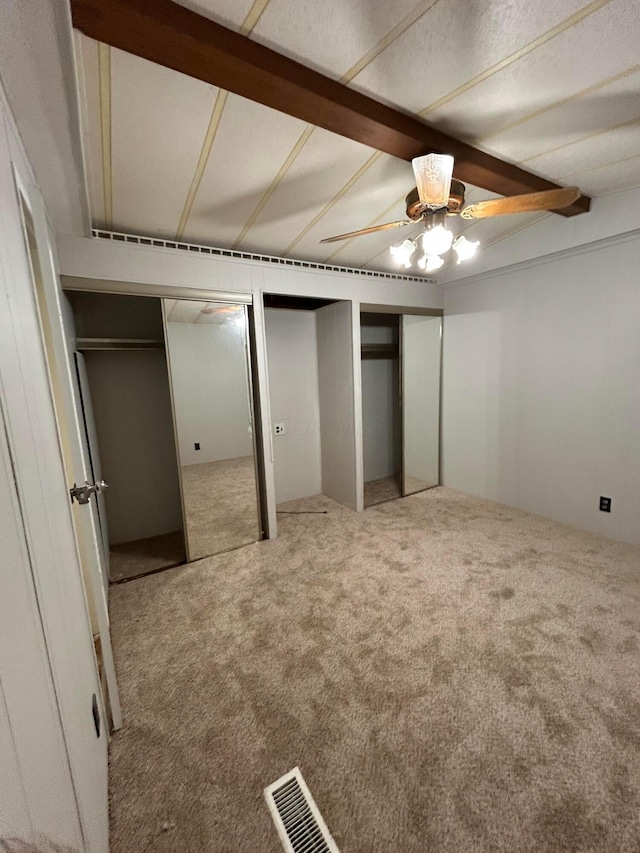 110 E Hickory Grove Rd Unit 45, Urbana, OH 43078 - unfurnished bedroom with carpet floors, multiple closets, beamed ceiling, and a ceiling fan