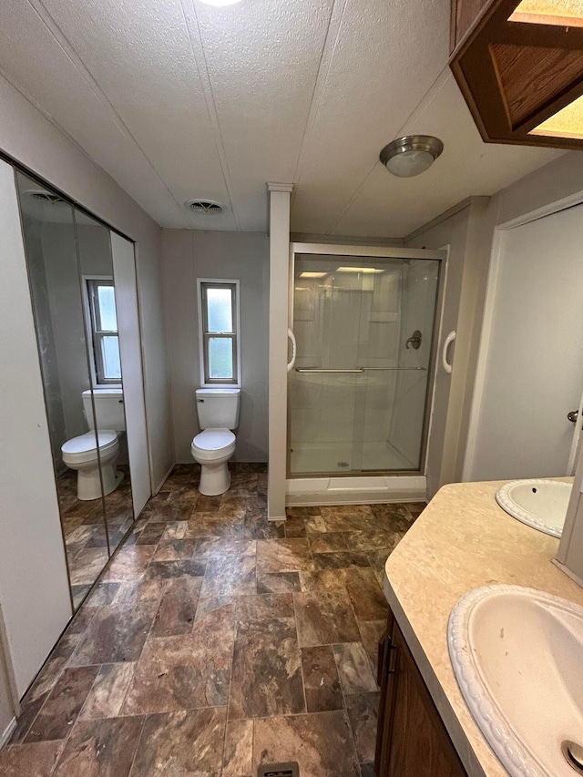 110 E Hickory Grove Rd Unit 45, Urbana, OH 43078 - bathroom featuring vanity, a stall shower, a textured ceiling, and stone finish floors