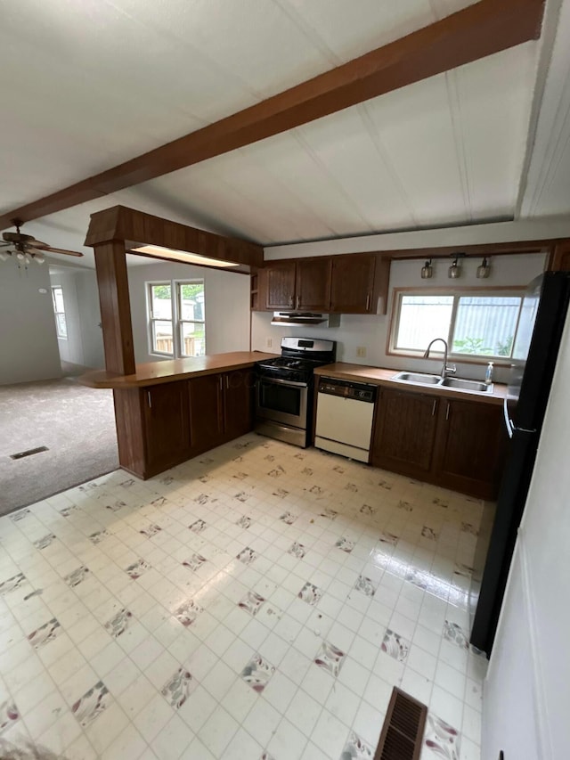 110 E Hickory Grove Rd Unit 45, Urbana, OH 43078 - kitchen featuring white dishwasher, stainless steel range with gas cooktop, freestanding refrigerator, a peninsula, and dark brown cabinetry
