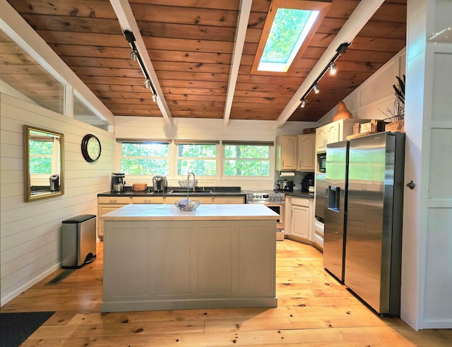 82 Lodge Ln, Hide A Way Hills, OH 43107 - kitchen with rail lighting, stainless steel appliances, wood ceiling, a skylight, and a kitchen island