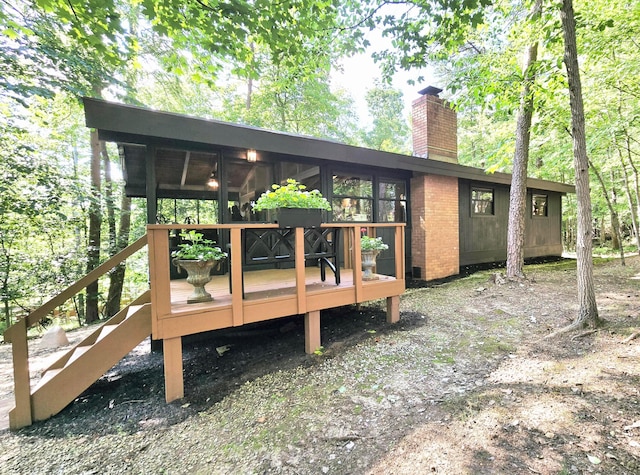 82 Lodge Ln, Hide A Way Hills, OH 43107 - back of house featuring a chimney, a deck, and a sunroom