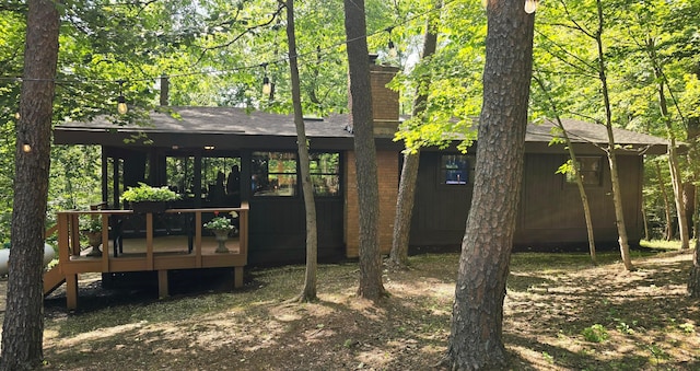 82 Lodge Ln, Hide A Way Hills, OH 43107 - back of house featuring a chimney, a wooden deck, and a shingled roof