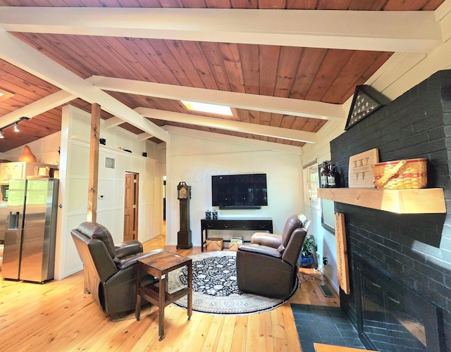 82 Lodge Ln, Hide A Way Hills, OH 43107 - living area with light wood finished floors, wooden ceiling, and a fireplace with flush hearth