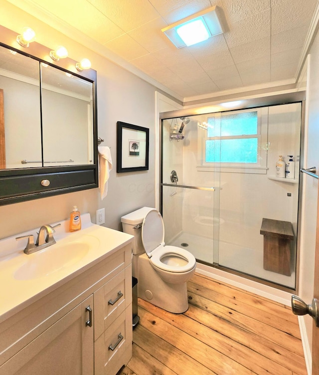 82 Lodge Ln, Hide A Way Hills, OH 43107 - full bathroom with ornamental molding, vanity, a shower stall, and hardwood / wood-style floors