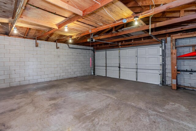 1366 S 4th St, Columbus, OH 43207 - garage featuring a garage door opener and concrete block wall