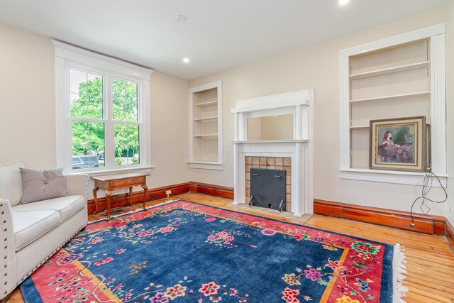 1366 S 4th St, Columbus, OH 43207 - living area featuring built in features, wood finished floors, a fireplace, and recessed lighting